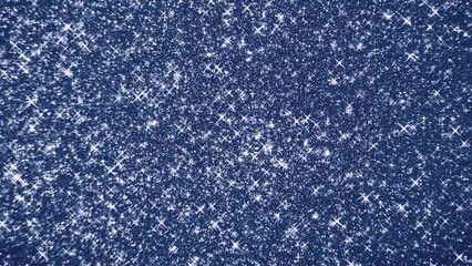 Illustration of glitter stars glowing on blue background