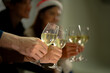 © ultramansk - close up glasses of clinking glasses of champagne with lighting. Party of asian friend female and male celebrating. happiness friends christmas eve celebrate dinner party with food and champagne.