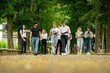 © qunica.com - Big young group of college campus students walking together outside with books and backpacks talking to each other going back to school
