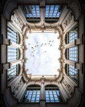 Ornate Courtyard With Flying Birds