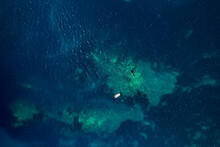 Top View Of Sailboat In Turquoise Waters