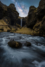 Turbulent Waterfall In Rocky Gorge At Night In Iceland