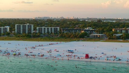 Wall Mural - Aerial evening seascape with Siesta Key sandy beach in Sarasota, USA. Many tourists enjoying summer vacation time swimming in warm Mexico gulf water and sunbathing on hot Florida sun