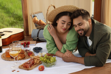 Wall Mural - Romantic date. Beautiful couple spending time together during picnic in wooden gazebo