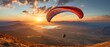 A person paragliding at dusk - A concept of adventure, travel, independence, and thrill sports.