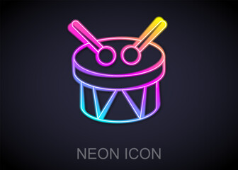 Canvas Print - Glowing neon line Musical instrument drum and drum sticks icon isolated on black background. Vector