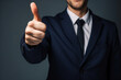 Businessman with thumb up gesture, Unrecognizable man showing thumb up gesture on dark blue background