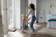 © fizkes - Young woman and daughter dancing to favourite music in cozy, warm bedroom. Loving mom and child holding hands, having fun together on carefree pastime at home, feel happy looking overjoyed. Fun, hobby