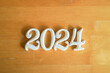 close up white number 2023 shape wood on retro brown background for happy new year countdown concept
