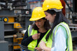 © Wosunan - Two female engineers working together in metal sheet factory. This is a freight transportation and distribution warehouse. Industrial and industrial workers concept