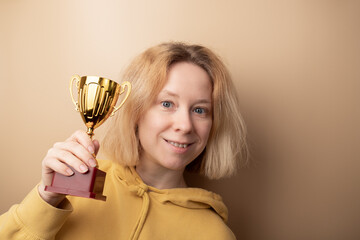 Wall Mural - award, sport cup, success, trophy, first place, the winner of the competition holds a gold prize