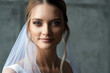 The bride in a white dress with a veil. Portrait of a girl in a wedding dress.