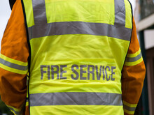 Close Up Rear View Of Rural Fire Fighter In Uniform