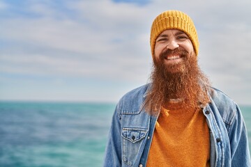 Canvas Print - Young redhead man smiling confident standing at seaside