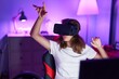 © Krakenimages.com - Young beautiful hispanic woman streamer playing video game using virtual reality glasses at gaming room