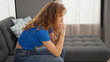 © Krakenimages.com - Young woman stressed sitting on sofa at home