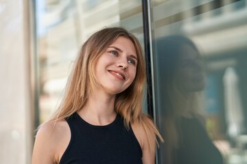 Poster - Young blonde woman smiling confident looking to the side at street