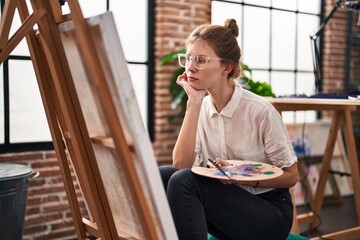 Canvas Print - Young blonde woman artist looking draw thinking at art studio