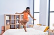© Krakenimages.com - African american woman smiling confident dancing on bed at bedroom