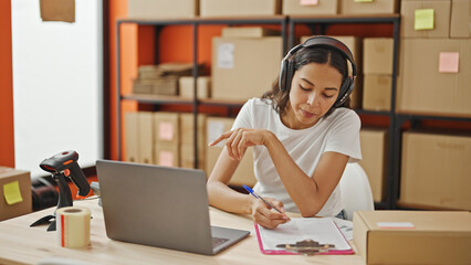 Poster - African american woman ecommerce business worker having video call writing on document at office