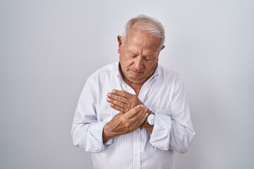 Wall Mural - Senior man with grey hair standing over isolated background suffering pain on hands and fingers, arthritis inflammation