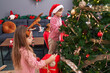 © Krakenimages.com - Brother and sister decorating christmas tree at home