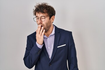 Sticker - Hispanic business man wearing glasses bored yawning tired covering mouth with hand. restless and sleepiness.