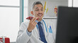 © Krakenimages.com - Young hispanic man doctor sending voice message by smartphone using computer at clinic