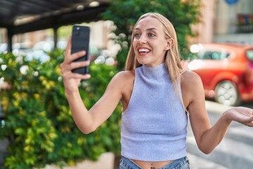 Sticker - Young caucasian woman doing video call with smartphone celebrating achievement with happy smile and winner expression with raised hand