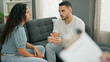 © Krakenimages.com - Man and woman sitting on sofa having couple therapy at psychology clinic