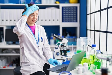 Sticker - Hispanic woman working at scientist laboratory stressed and frustrated with hand on head, surprised and angry face