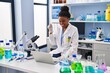 © Krakenimages.com - Young african american with braids working at scientist laboratory with laptop screaming proud, celebrating victory and success very excited with raised arm