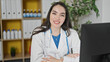 © Krakenimages.com - Young beautiful hispanic woman doctor using computer smiling at the clinic