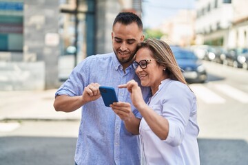 Canvas Print - Man and woman mother and daugther using smartphone at street