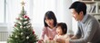 © ETAJOE - Asian Family celebrating christmas new year and. Home holiday and Christmas tree