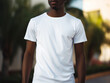 © JQM - A young black male (African American) model wearing a white t-shirt, no face, mockup, in an outdoor setting
