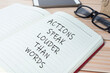 Actions speak louder than words text on notepad. Business concept.