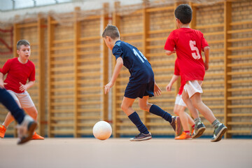 Wall Mural -  Kids playing football soccer game on sports field.