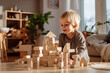 Cute little child playing with wooden blocks. Sustainable eco friendly toys