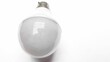 © Wirestock - Closeup of a light bulb on a white background
