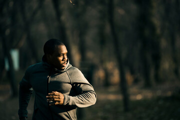 Wall Mural - Young black man running in the park