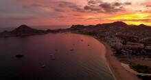 Nautical Morning Crimson Sunrise And Luxury Yachts In Cabo Bay