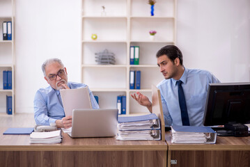 Wall Mural - Two male colleagues working in the office