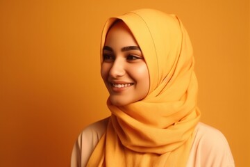 Wall Mural - Smiling happy arab asian muslim woman in yellow hijab clothes isolated on yellow background studio portrait. Uae people middle east islam religious concept. generative AI