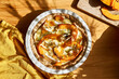 Autumn healthy eating. Delicious seasonal tart with baked pumpkin, brie cheese and herbs on wooden table.