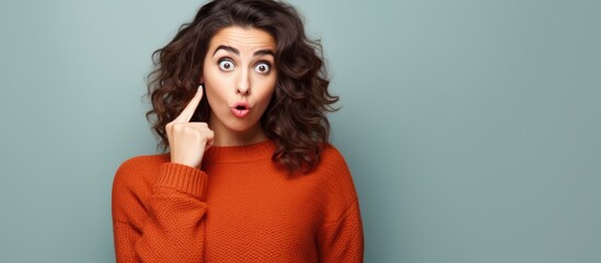 Canvas Print - A funny expression is being made by a plus size woman with beautiful dark hair who is wearing a casual sweater as she poses in front of a white background She is making a silly facial gestu