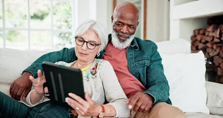 Wall Mural - Old couple on sofa with tablet, smile and relax with love, interracial marriage and bonding in home. Social media meme, digital app and happy people, senior man and woman on couch in living room.