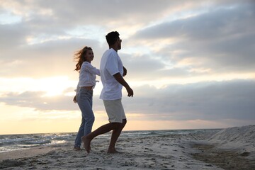 Poster - Happy couple dancing on beach at sunset