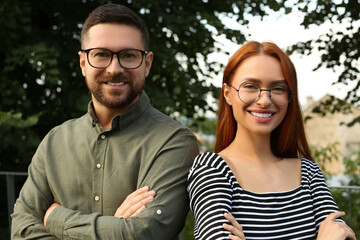 Wall Mural - Portrait of happy couple in glasses outdoors