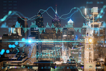 Aerial panoramic cityscape of Philadelphia financial downtown at summer night time, Pennsylvania, USA. Glowing forex candlesticks and bar graph hologram. The concept of internet trading and brokerage